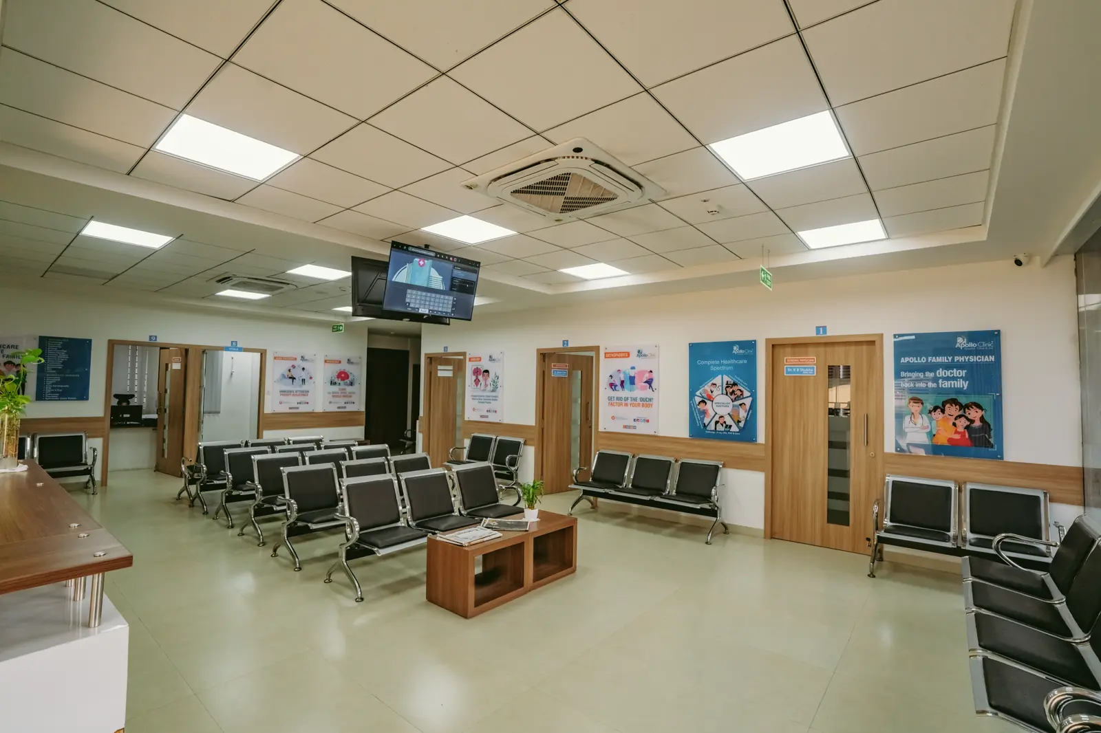 Reception and waiting hall by Candidscape at Apollo Clinic, Akshay Nagar, Bangalore, with rows of waiting seats and health information boards