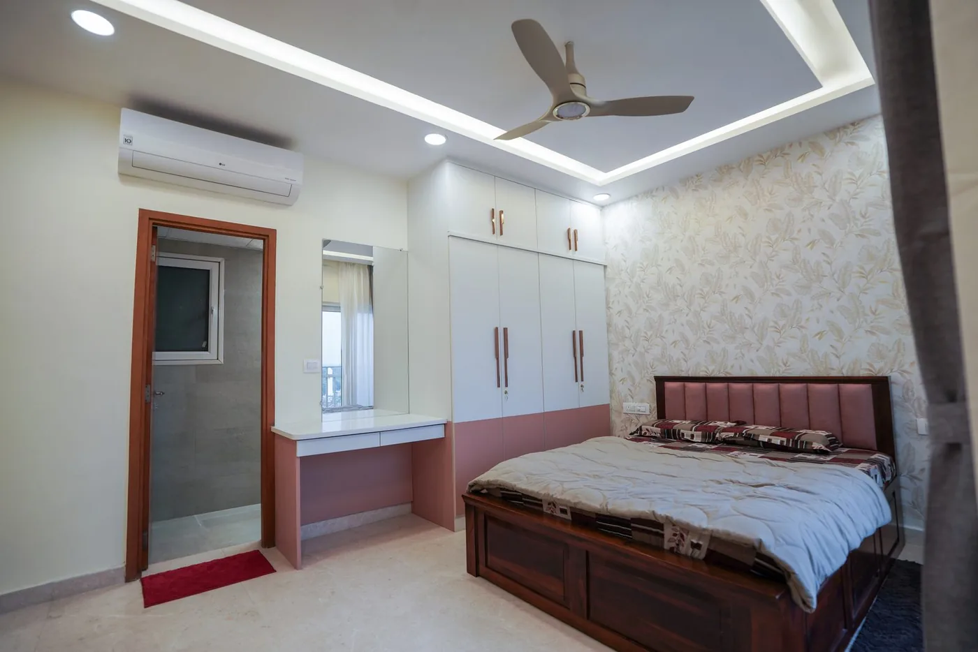 Bedroom by Candidscape at RMZ City View, Bangalore, with a floor-to-ceiling built-in wardrobe, a study ledge and an upholstered bed