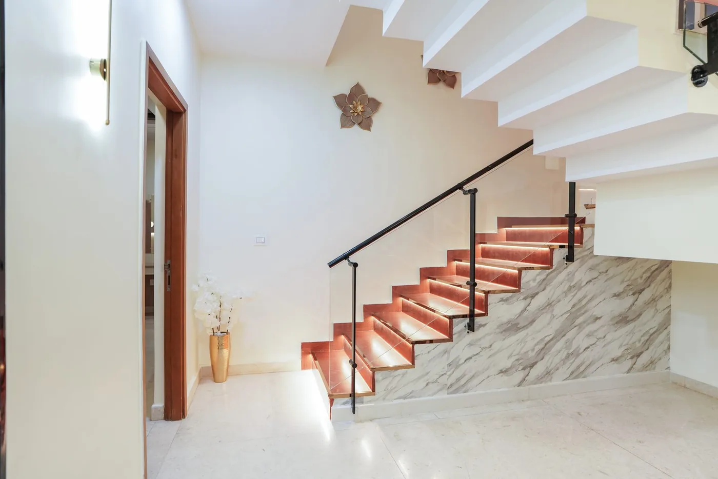 RMZ City View Staircase � Marble steps framed by full-height glass.